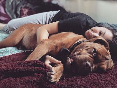 Zoie Laurel May Herpin is lying down with Eeyore.